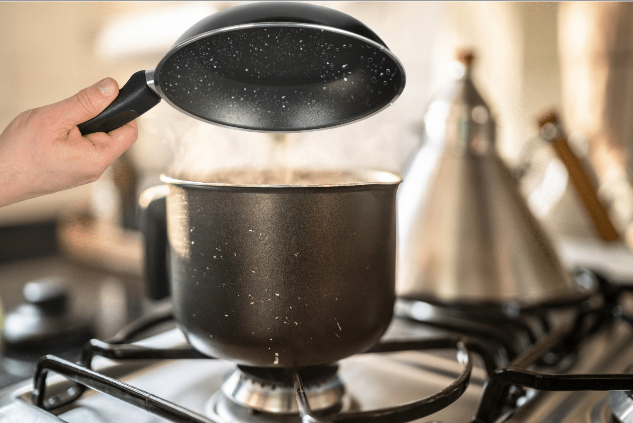 Water droplets inside pan held over boiling water.