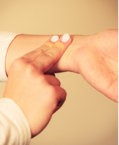 Person reading pulse using their fingers.
