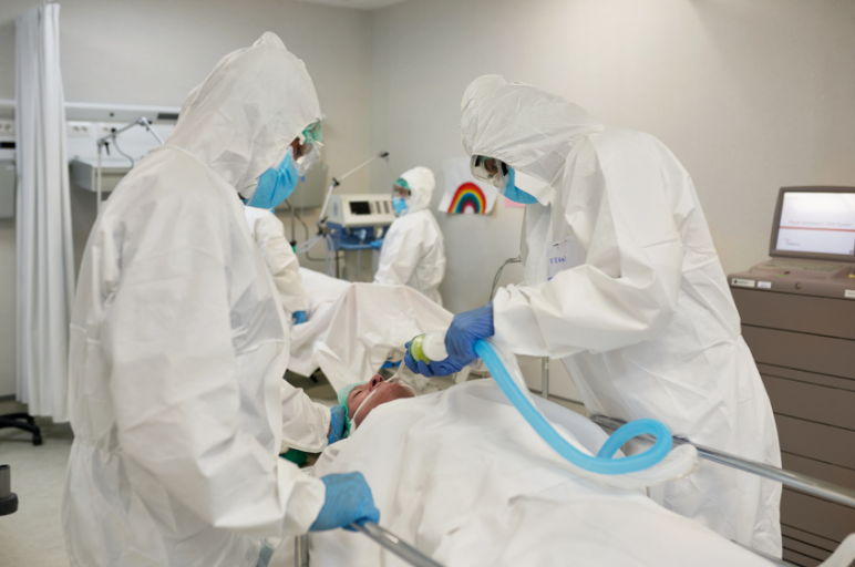 Doctors putting a patient on ventilator.