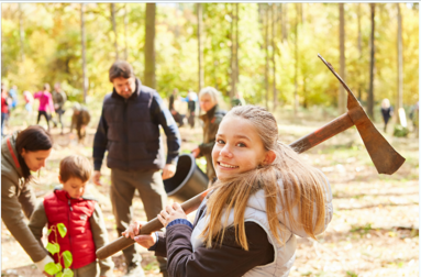 People planting trees near a forest.