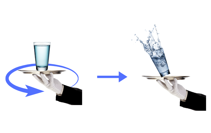Hand holding a tumbler on a tray, which is being whirled around.